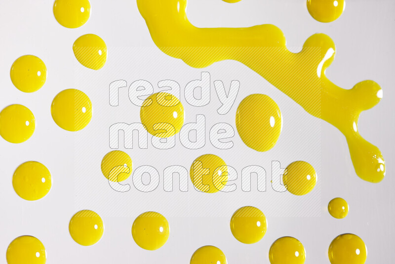Close-ups of abstract yellow paint droplets on white background