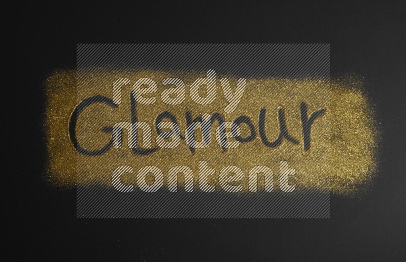 A word written with gold glitter on black background