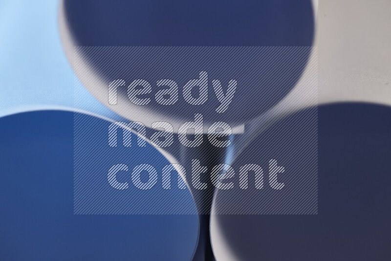 The image shows an abstract paper art with circular shapes in varying shades of blue