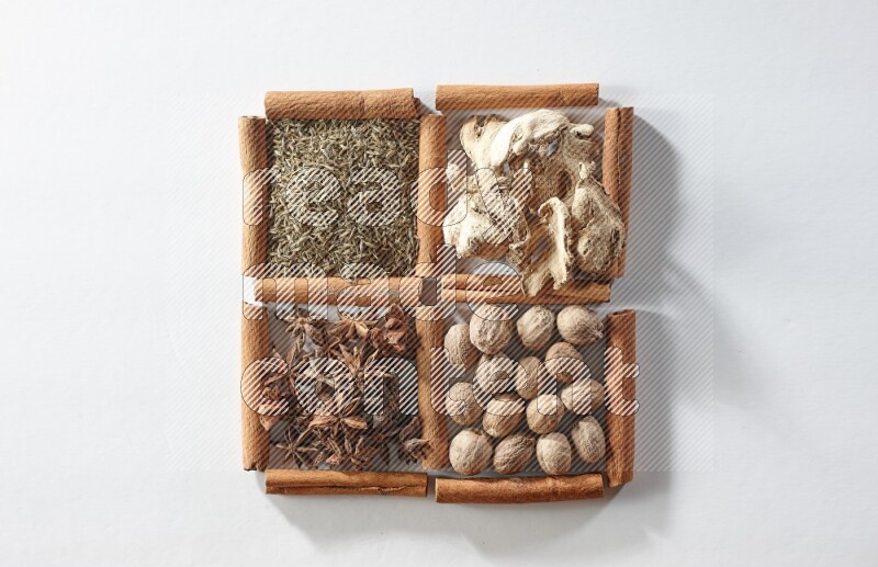 4 squares of cinnamon sticks full of star anise, ginger, cumin and nutmeg on white flooring