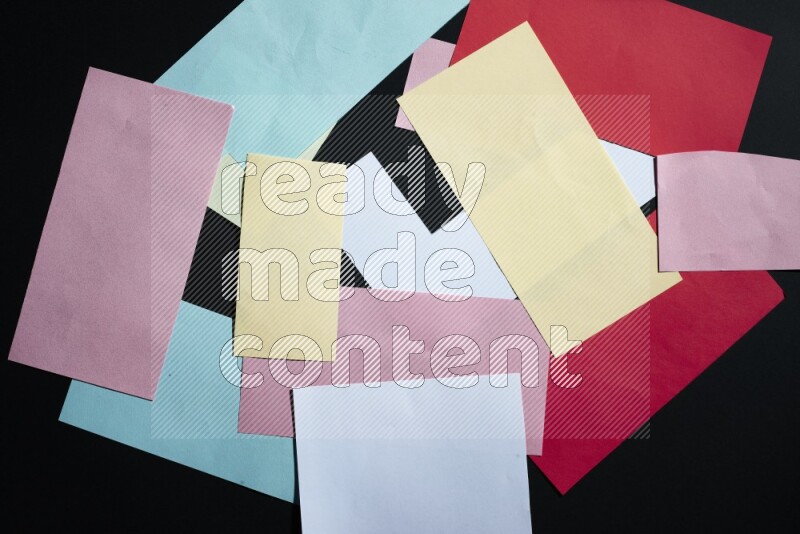 Multicolored paper sheet on black background