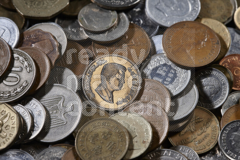 A close-ups of random old coins on black background