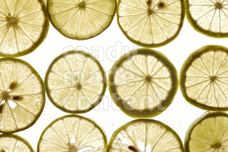 Lemon slices on illuminated white background