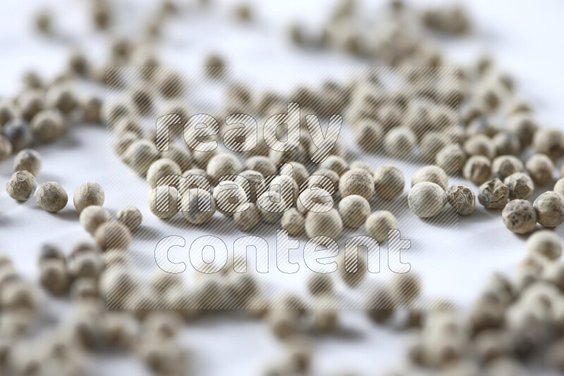 White pepper beads on white background