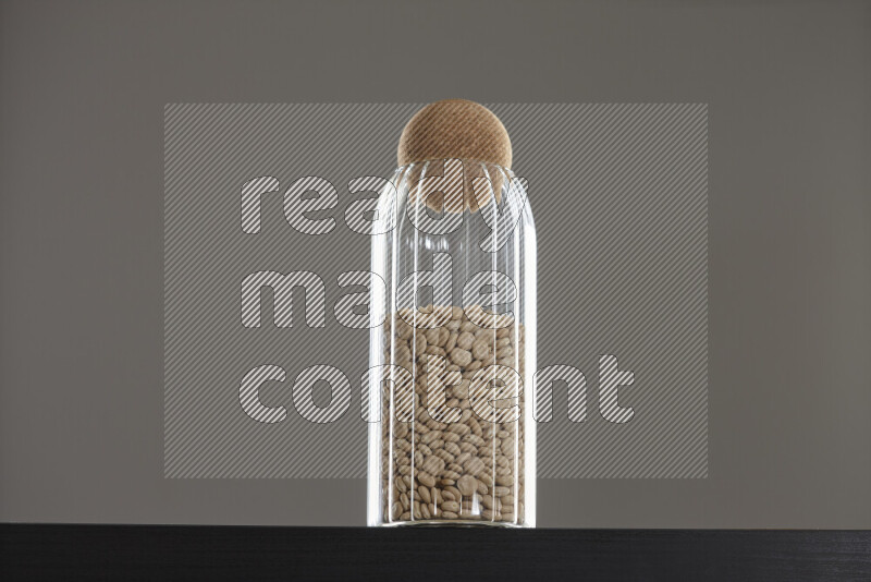 Lupin Beans in a glass jar on black background
