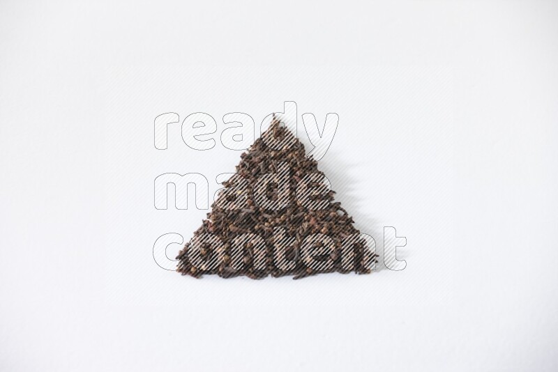 cloves in a triangle shape on a white flooring