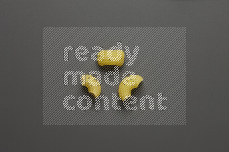 Elbow pasta on grey background
