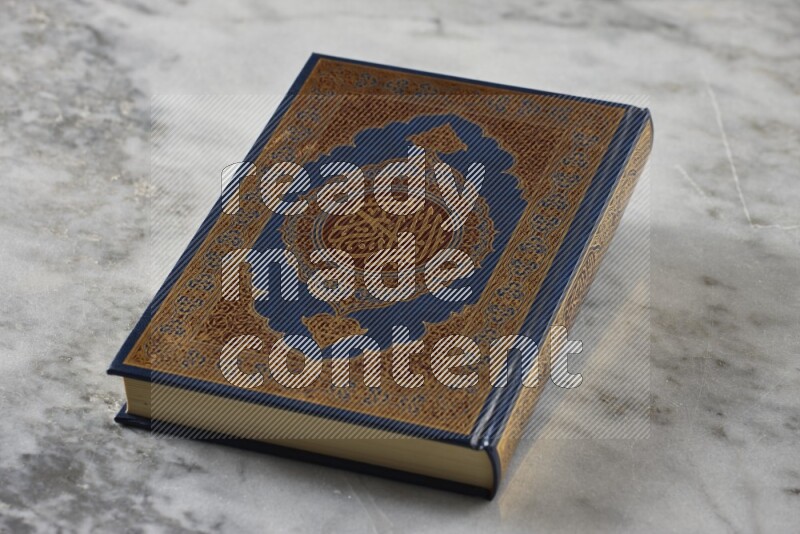 Quran with a prayer beads on grey marble background