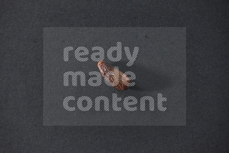 Dried dates on a black background in different angles