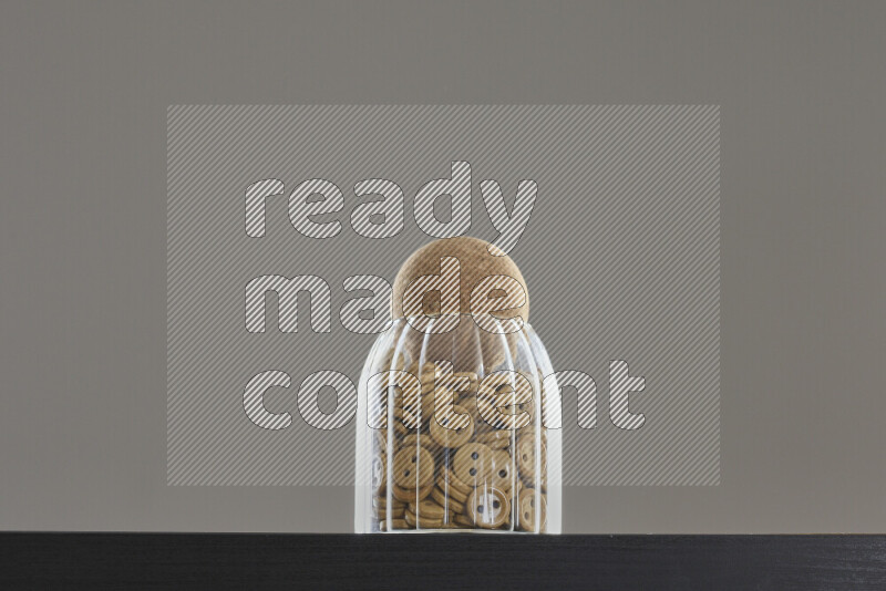 Buttons in a glass jar on black background