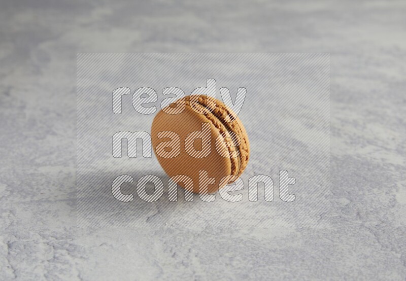45º Shot of Brown Maple Taffy macaron on white  marble background