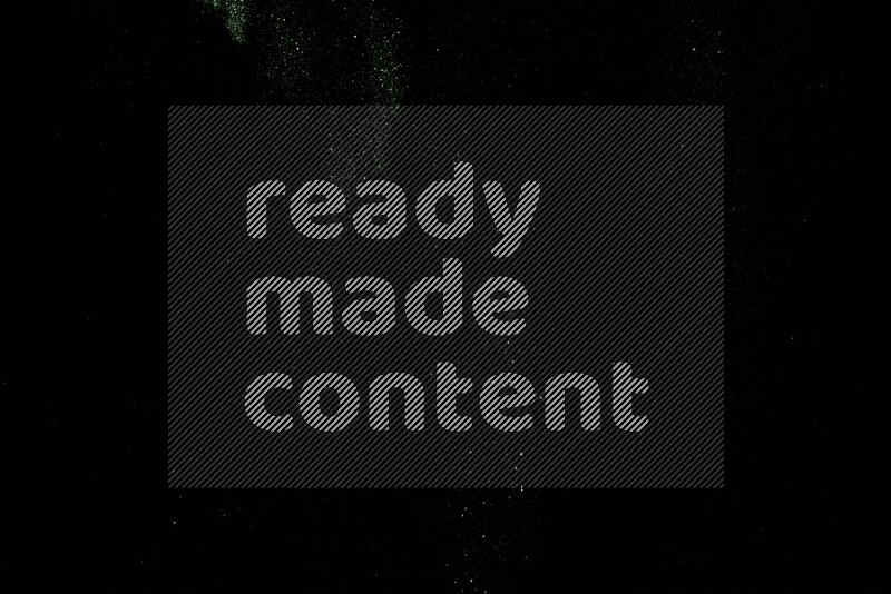 Green glitter powder isolated on black background