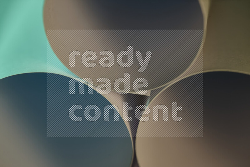 The image shows an abstract paper art with circular shapes in varying shades of green and warm tones