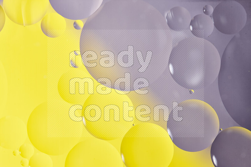 Close-ups of abstract oil bubbles on water surface in shades of white and yellow