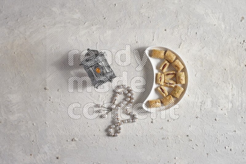 Oriental sweets in a pottery plate with lantern in a light setup