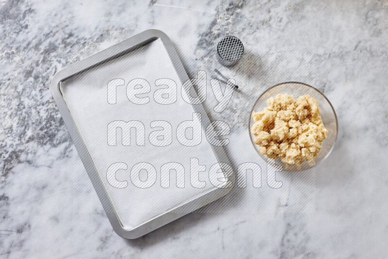 Kahk step by step with its ingredients ghee, sugar, flour, sesame, yeast, water and kahk flavor on grey marble background