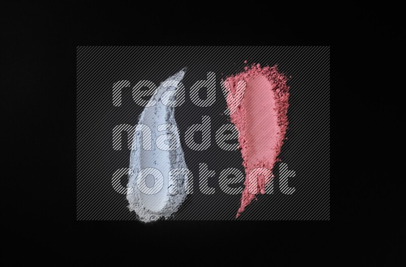 Multicolored powder smears on black background