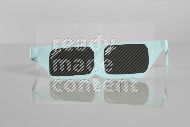 Origami sun glasses on grey background