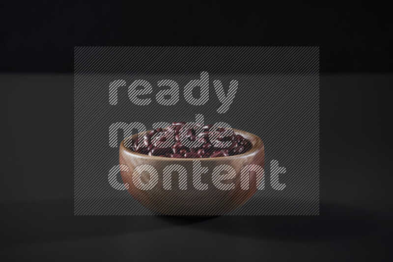 Red kidney beans in a wooden bowl on grey background