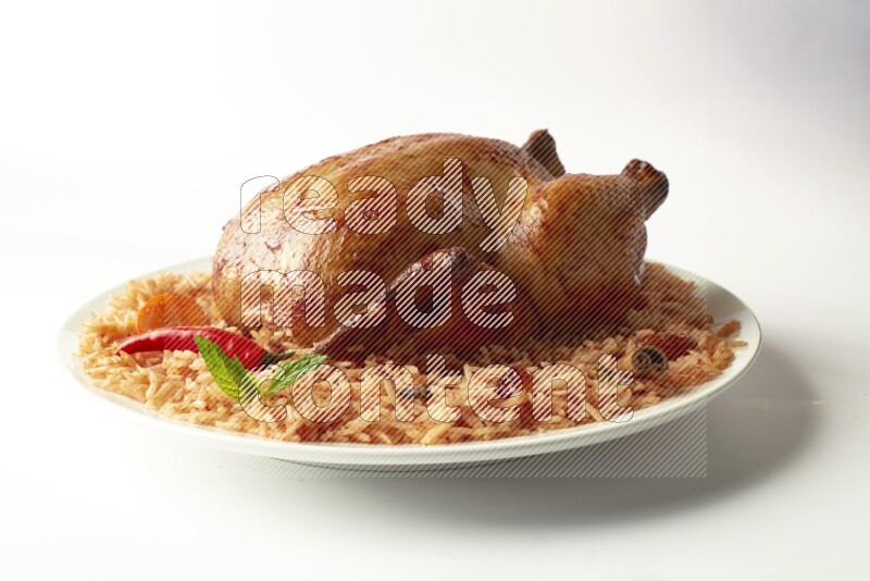 red basmati Rice with  whole roasted chicken on a white rounded plate  direct  on white background