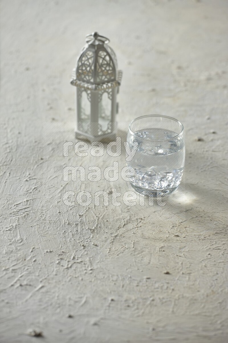 A white lantern with different drinks, dates, nuts, prayer beads and quran on white background