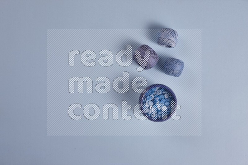 A blue collection of sewing and tailoring tools arranged on a blue background