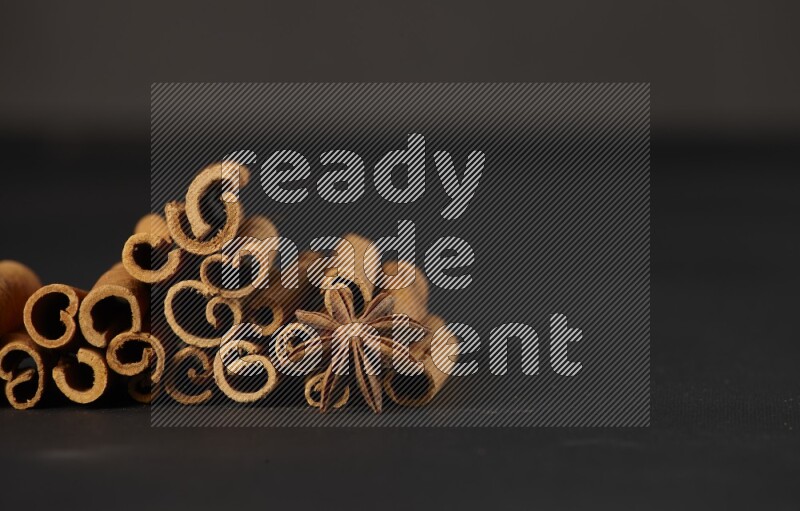 Cinnamon sticks and star anise on a black background