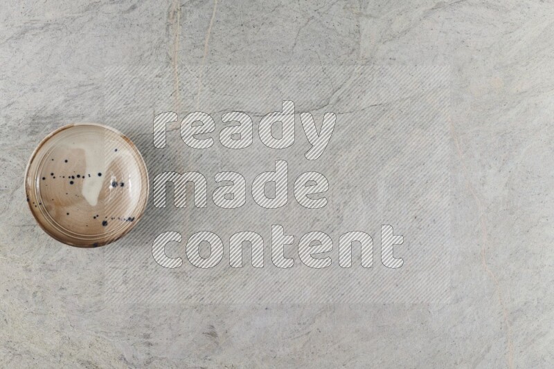 A multicolored pottery Bowl on grey marble background