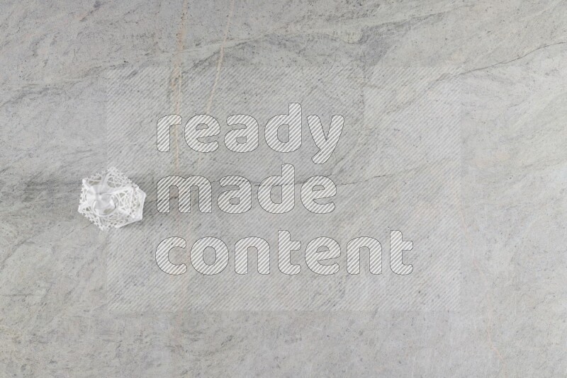A candle lantern on grey marble background