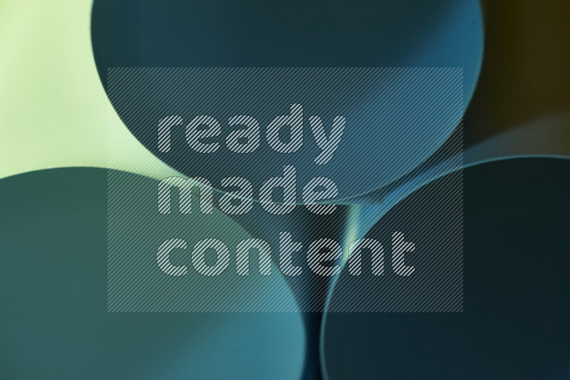 The image shows an abstract paper art with circular shapes in varying shades of green and blue
