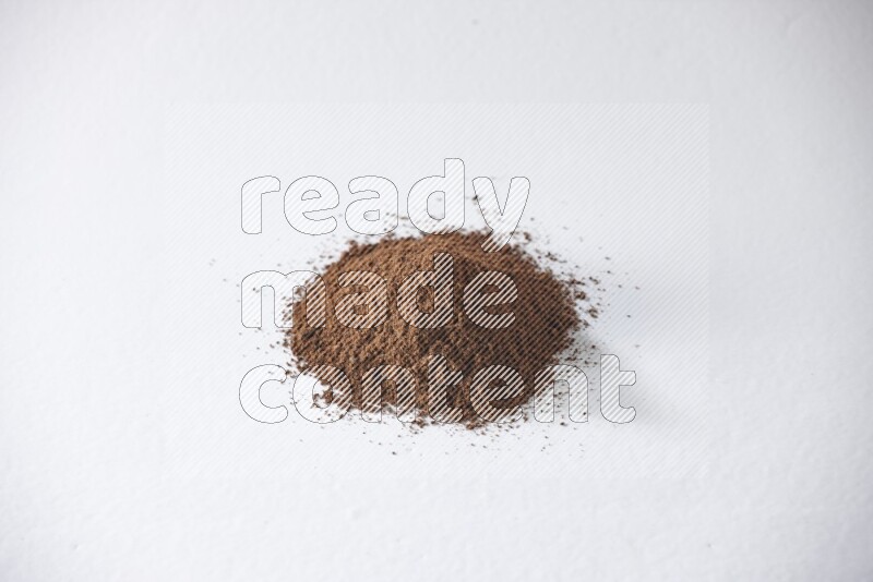 A pile of cloves powder on a white flooring