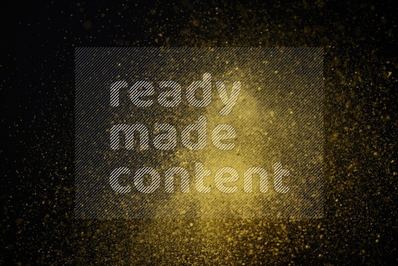 Yellow powder explosion on black background