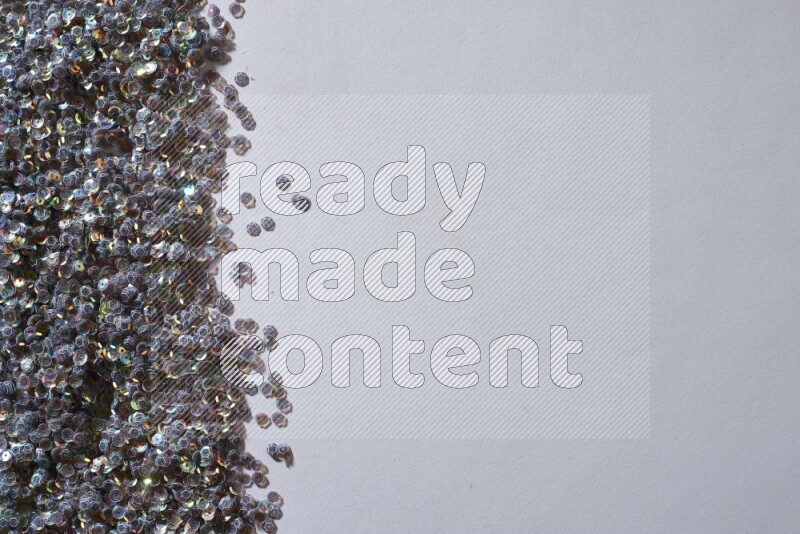 Multicolored flat sequins on grey background