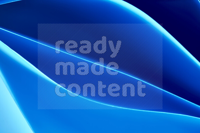 هذه الصورة تعرض تكوين فن الورق التجريدي مع منحنيات ورقية بتدرجات اللون الأزرق المكونه بواسطة الضوء الملون