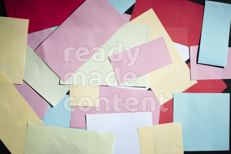 Multicolored paper sheet on black background