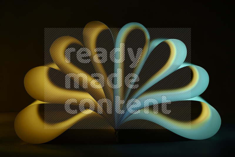An abstract art piece displaying smooth curves in yellow and green gradients created by colored light
