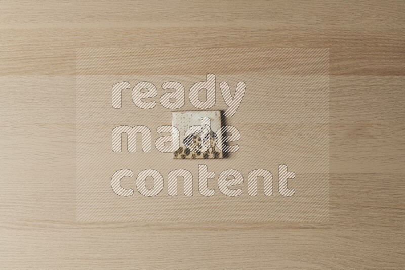 A decorative pottery coaster on light wooden background
