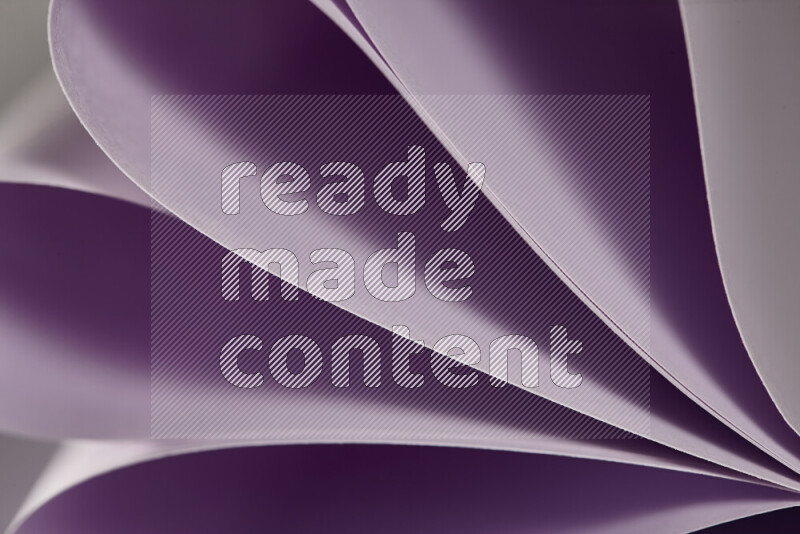 An abstract art showing purple paper sheets arranged in an overlapping curves