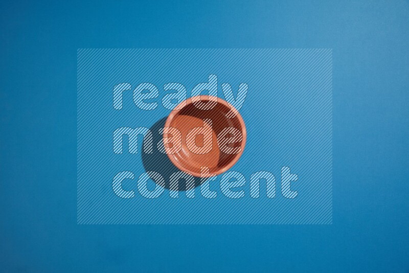 brown bowl on blue background