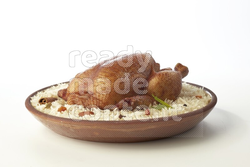 white  basmati Rice with  whole roasted chicken    on a pottery plate  direct  on white background
