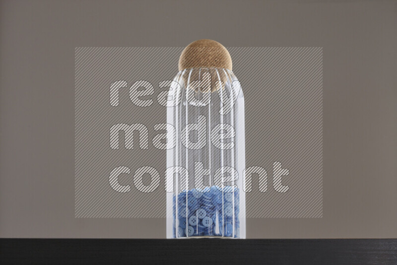 Buttons in a glass jar on black background