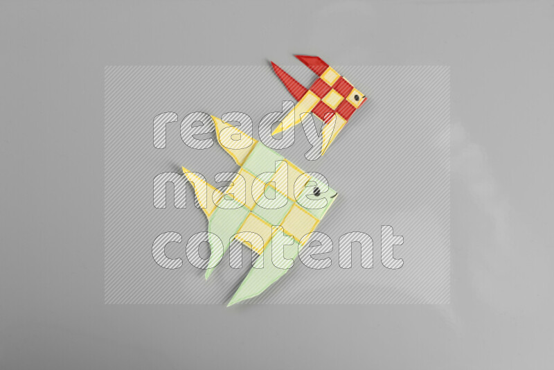 Origami fish on grey background