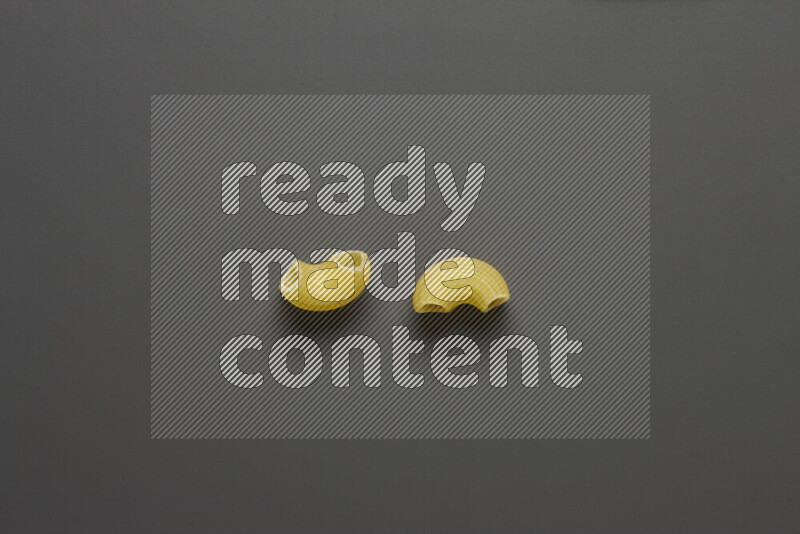Elbow pasta on grey background