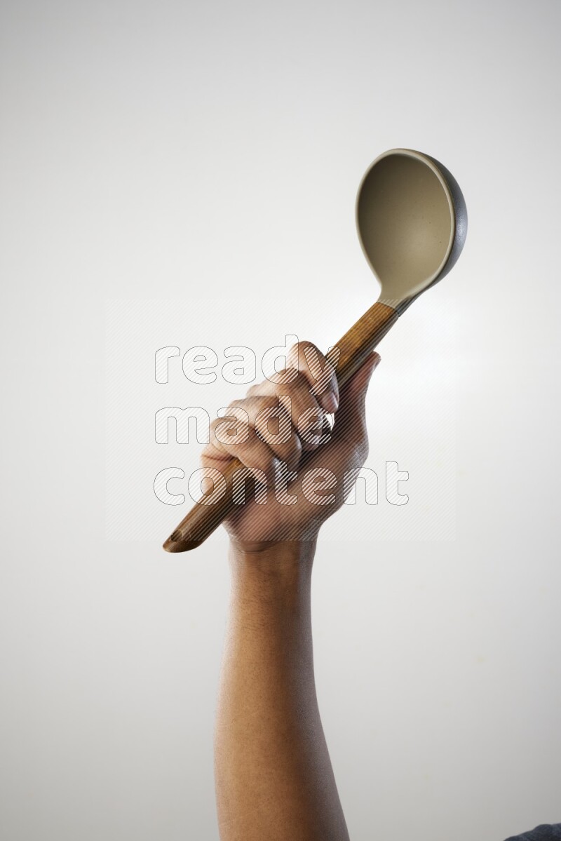 Male Hand Holding ladle on white background