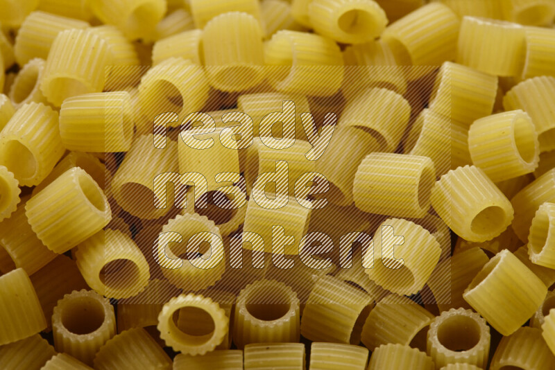 Big rings pasta on grey background
