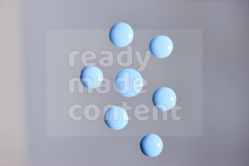 Close-ups of abstract blue paint droplets on the surface