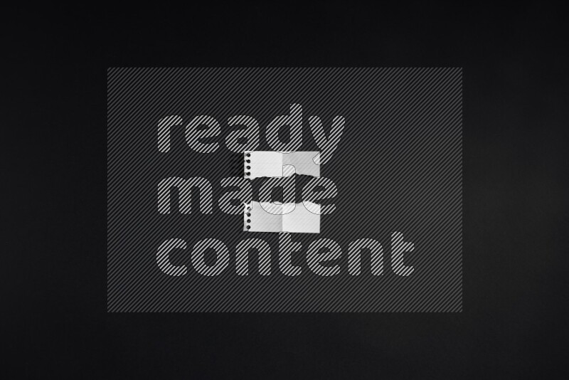 Ripped notebook sheet on black background