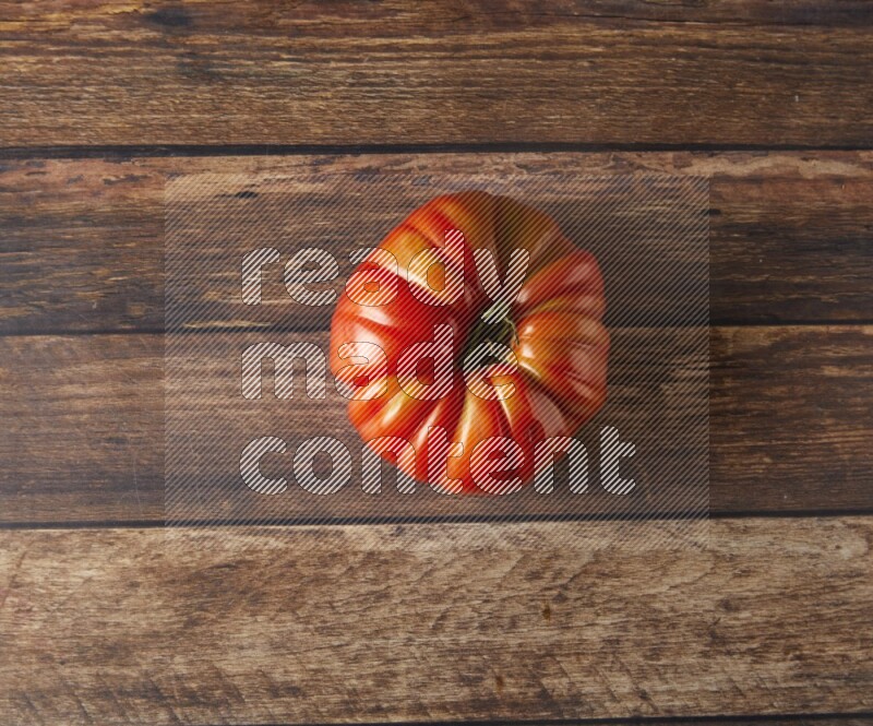 Single topview Heiloom Tomato on a wooden background
