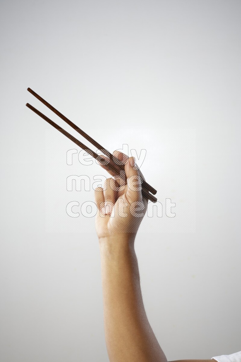Male Hand Holding Chop Stick on white background