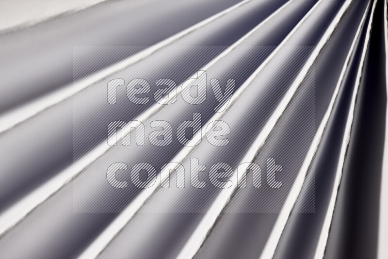 An image presenting an abstract paper pattern of lines in grey tones